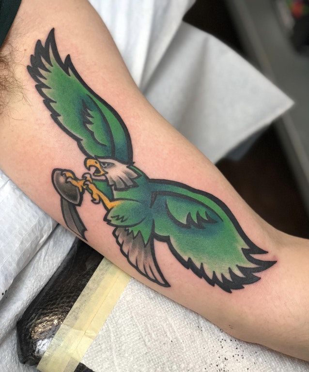 A Man S Back With A Philadelphia Eagles Tattoo On His Left Shoulder And