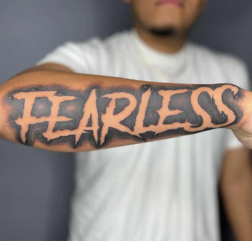 A Person With A Tattoo On Their Arm That Says Take The Fearless