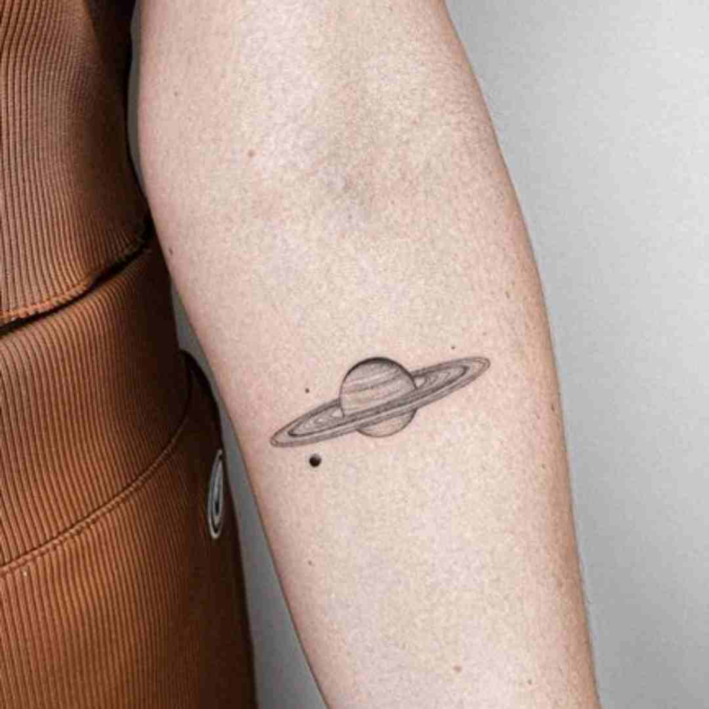 A Small Saturn Tattoo On The Arm