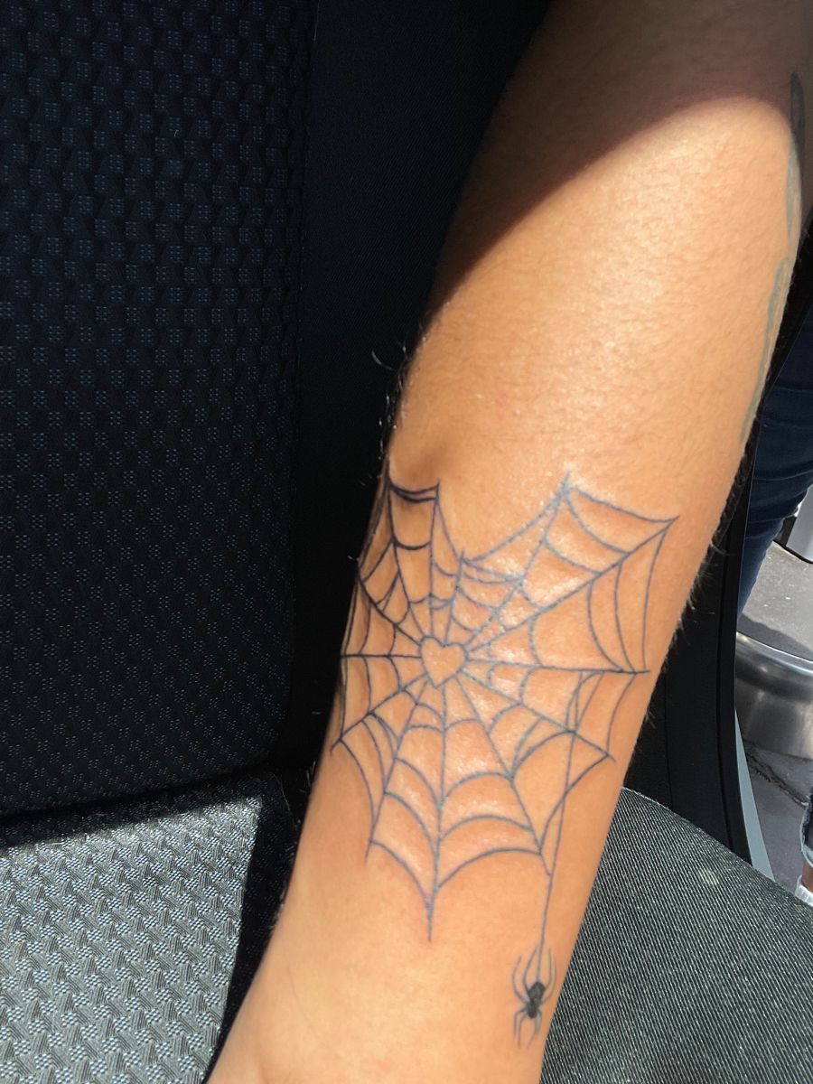 A Spider Web Heart Tattoo On The Leg