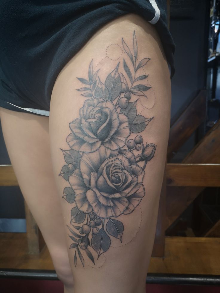 A Woman S Thigh With A Rose Tattoo On It